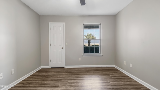 empty room with ceiling fan and dark hardwood / wood-style floors