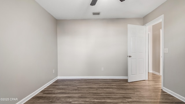 empty room featuring ceiling fan and dark hardwood / wood-style flooring