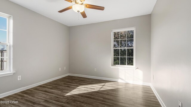 empty room featuring ceiling fan and dark wood-type flooring