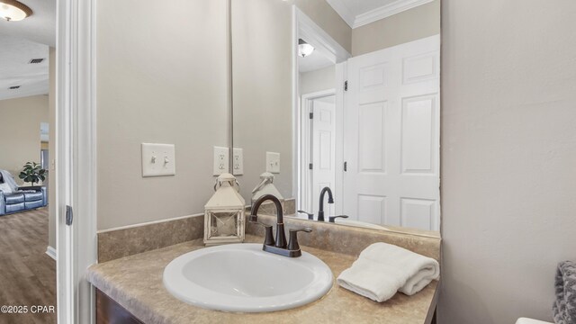 bathroom featuring visible vents, wood finished floors, and vanity