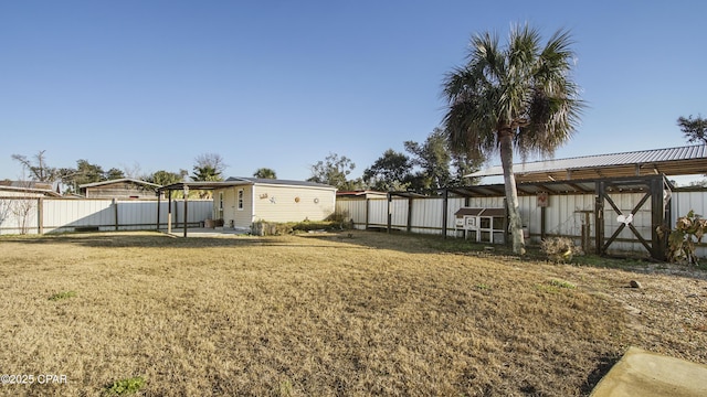 view of yard with an outbuilding and fence