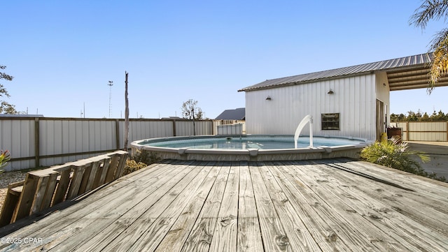 wooden deck featuring a fenced in pool and fence