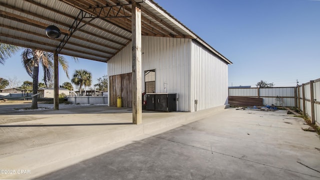 exterior space with fence and a carport