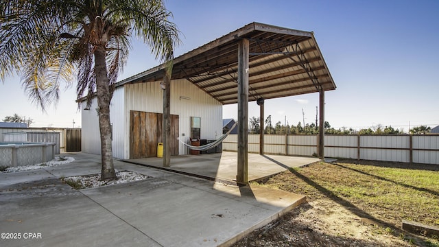 exterior space with a garage, fence, a fenced in pool, and concrete driveway