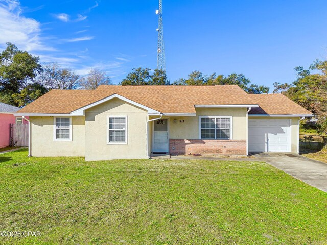 ranch-style home featuring a garage and a front lawn