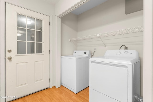 laundry area featuring hardwood / wood-style flooring and washer and clothes dryer