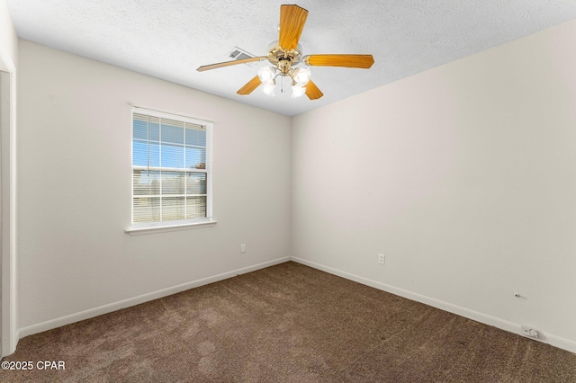 carpeted empty room featuring ceiling fan and a textured ceiling