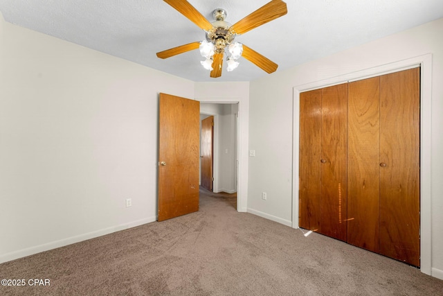 unfurnished bedroom featuring light carpet, ceiling fan, and a closet