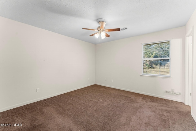 empty room with ceiling fan, carpet floors, and a textured ceiling