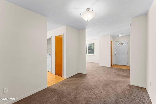 unfurnished room featuring light colored carpet