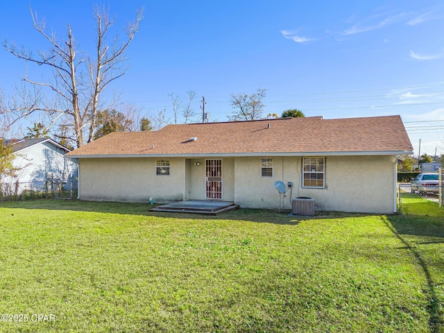 rear view of property with a lawn