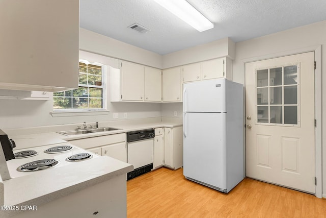 kitchen featuring white cabinetry, white appliances, sink, and light hardwood / wood-style flooring