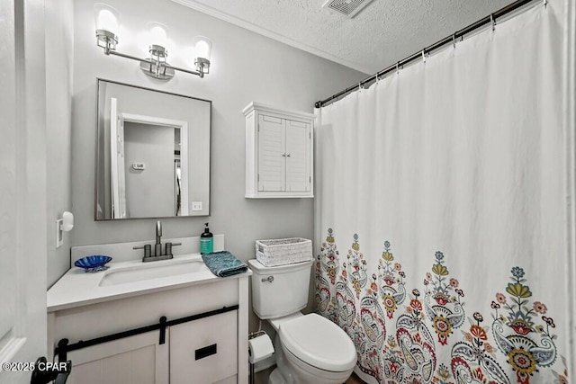 bathroom featuring vanity, toilet, and a textured ceiling