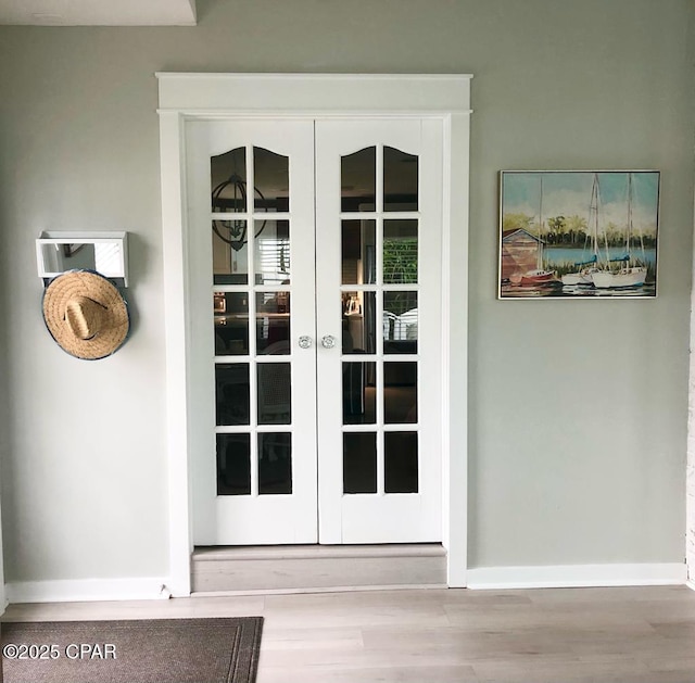 entryway with light hardwood / wood-style floors and french doors