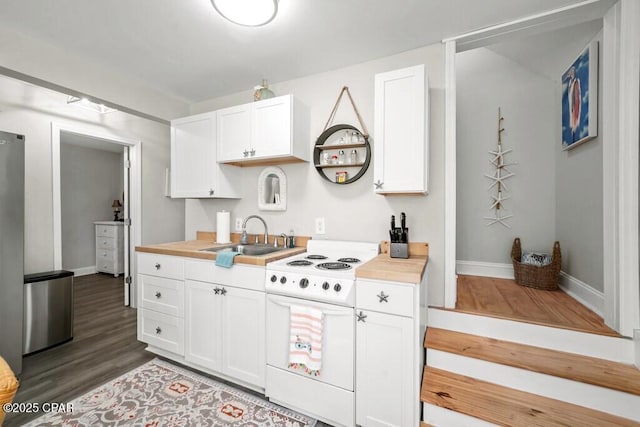 kitchen featuring dark wood-type flooring, sink, white electric stove, butcher block countertops, and white cabinetry