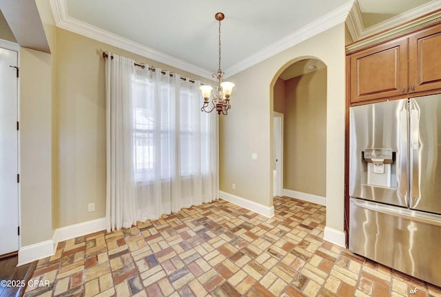 kitchen featuring pendant lighting, stainless steel fridge, ornamental molding, and a chandelier