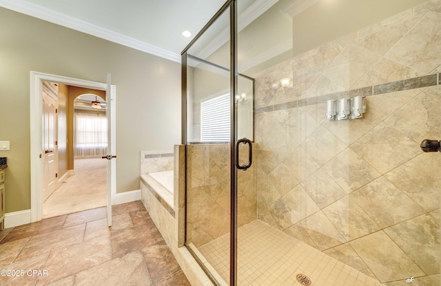 bathroom featuring ceiling fan, ornamental molding, and plus walk in shower