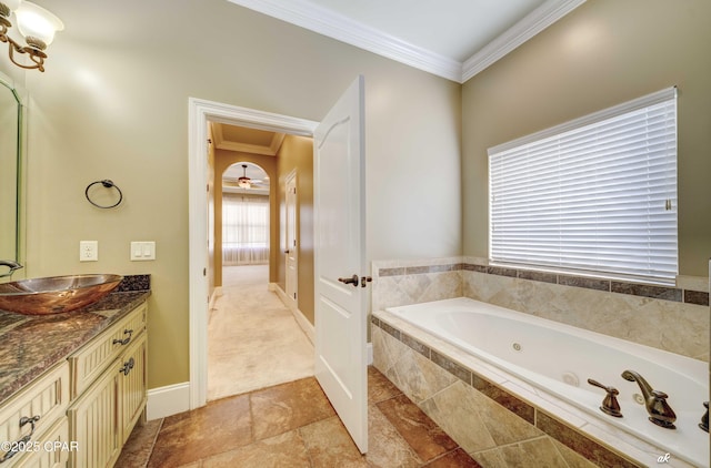 bathroom featuring ornamental molding, vanity, and tiled tub