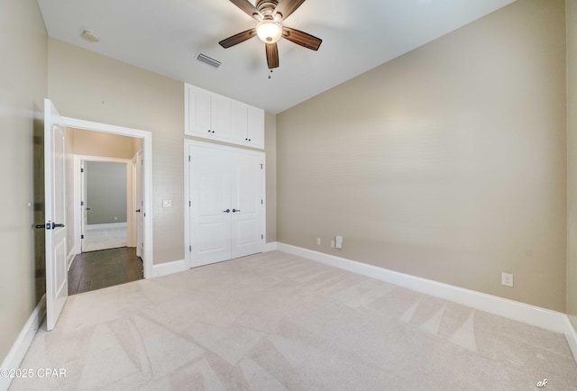 unfurnished bedroom featuring carpet flooring, ceiling fan, and a closet