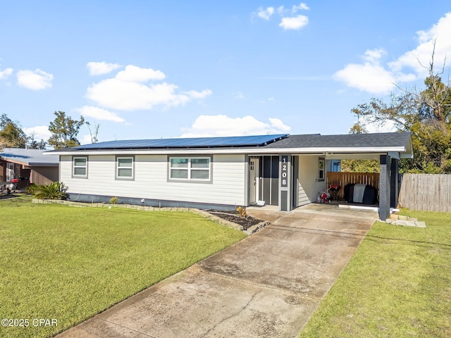 view of front of home with a carport and a front lawn