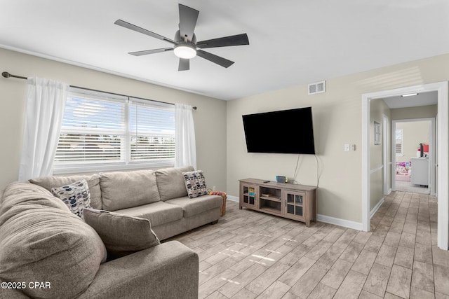 living room featuring ceiling fan and light hardwood / wood-style flooring