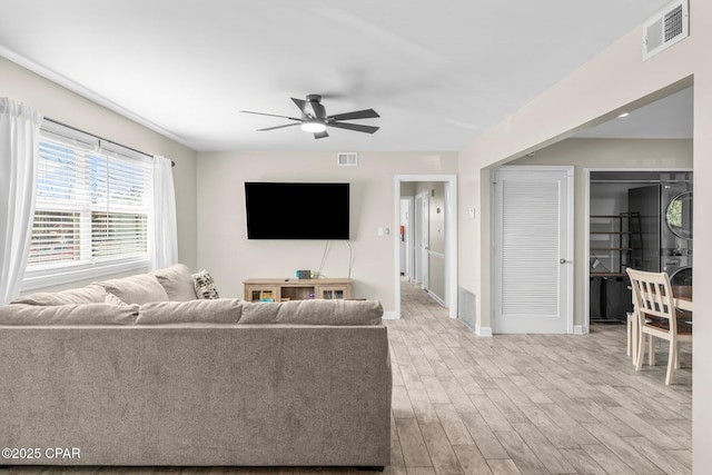 living room featuring ceiling fan and light wood-type flooring