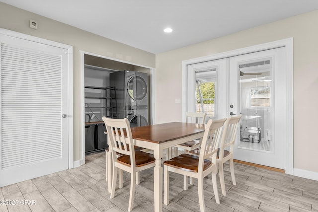 dining space with french doors and stacked washer and dryer