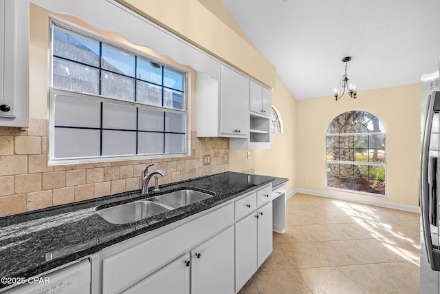 kitchen with decorative backsplash, decorative light fixtures, white cabinetry, and sink