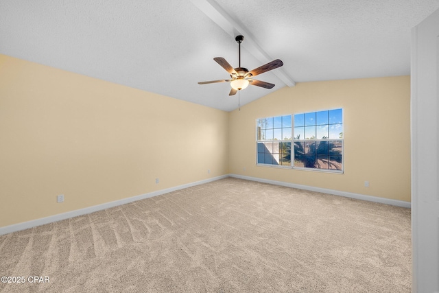 spare room featuring carpet flooring, a textured ceiling, lofted ceiling with beams, and ceiling fan