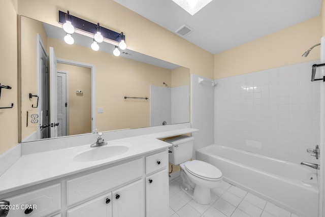 full bathroom featuring a skylight, tile patterned floors,  shower combination, toilet, and vanity