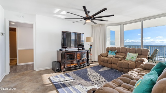 living room with expansive windows and ceiling fan