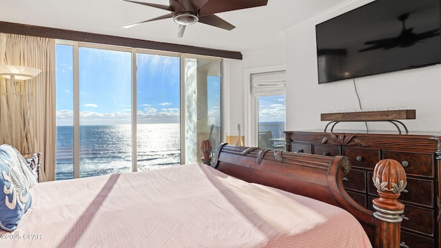 bedroom featuring multiple windows, access to outside, a water view, and ceiling fan