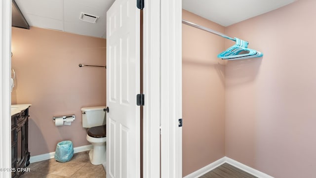 bathroom featuring vanity and toilet