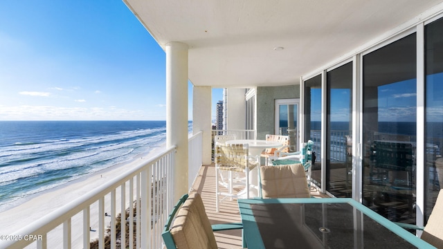 balcony with a beach view and a water view