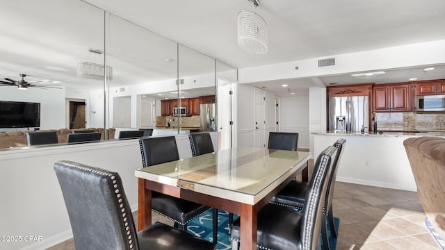 dining space featuring light tile patterned floors and ceiling fan