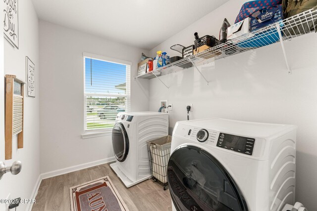 washroom featuring separate washer and dryer and light hardwood / wood-style floors