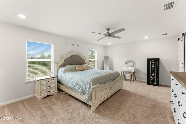 bedroom with multiple windows, light carpet, and ceiling fan