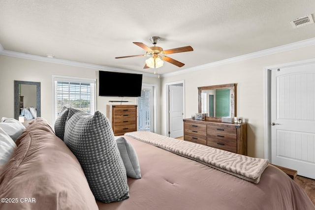 bedroom featuring a textured ceiling, hardwood / wood-style flooring, ceiling fan, and ornamental molding