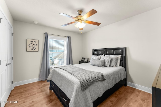 bedroom featuring ceiling fan, a closet, and wood-type flooring