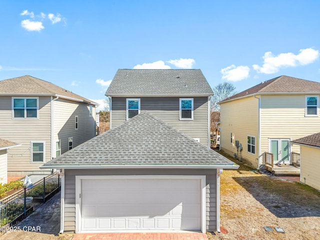 rear view of property with a garage