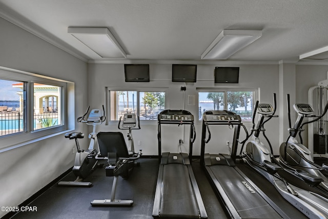 exercise room featuring crown molding and a textured ceiling