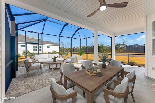 view of patio / terrace featuring outdoor dining space, a ceiling fan, a lanai, and outdoor lounge area