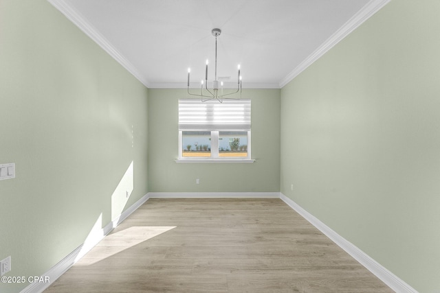 unfurnished dining area with an inviting chandelier, baseboards, crown molding, and light wood-type flooring
