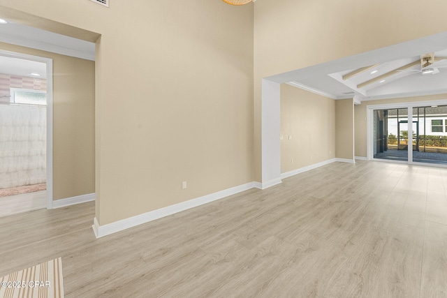 spare room featuring baseboards, recessed lighting, light wood-style flooring, and beamed ceiling