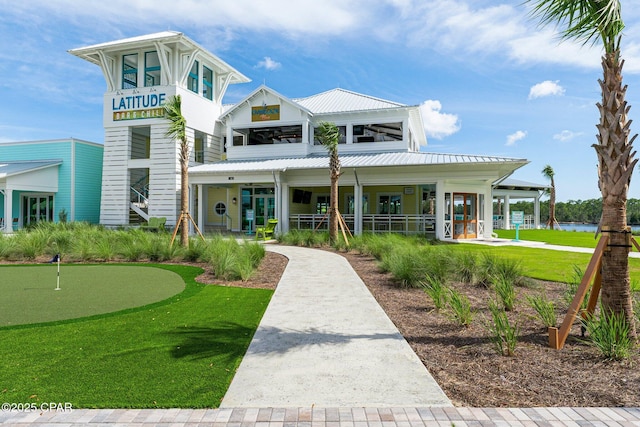 view of front facade with a water view and metal roof