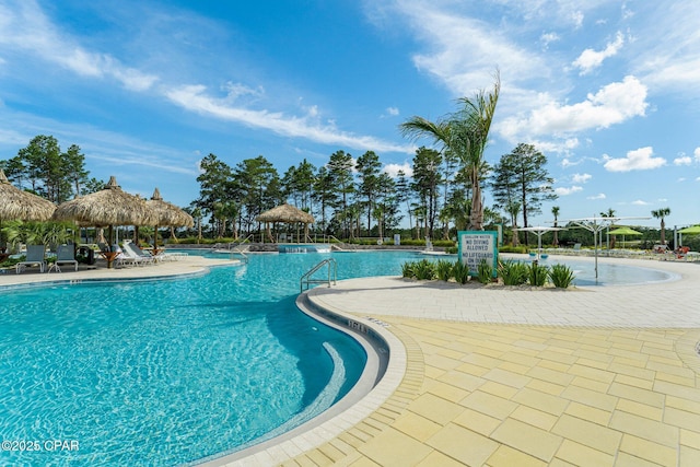 community pool with a gazebo and a patio