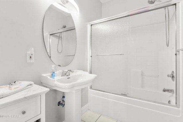 bathroom with tile patterned floors, toilet, and combined bath / shower with glass door