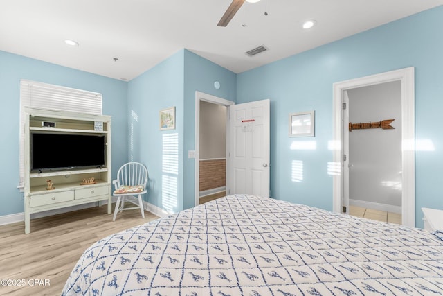 bedroom with ceiling fan and light hardwood / wood-style floors