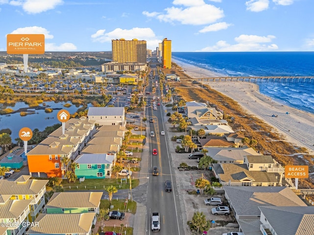 birds eye view of property featuring a water view and a beach view