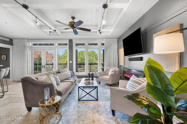 kitchen featuring light stone counters, wall chimney exhaust hood, stainless steel appliances, sink, and wine cooler